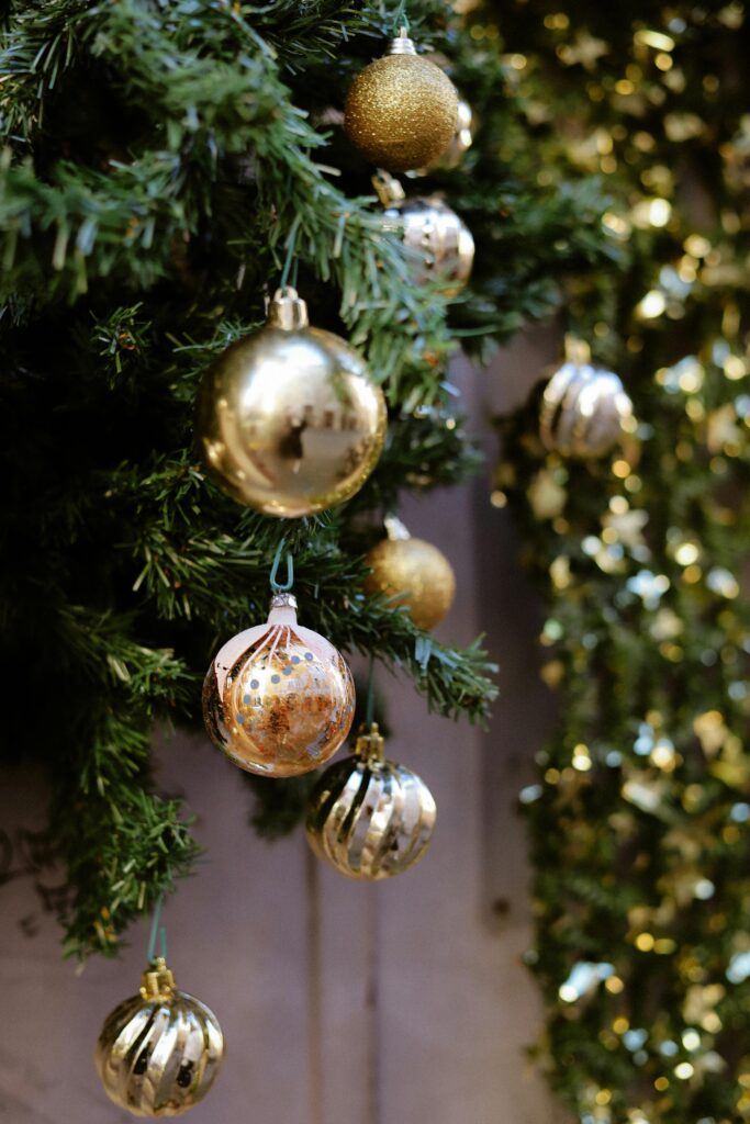 Elegant Christmas tree with golden ornaments in soft focus, embodying holiday spirit.