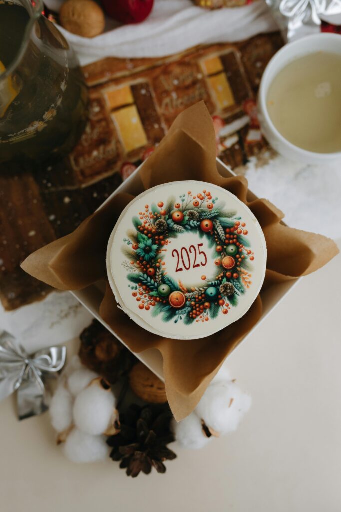 A beautifully decorated 2025 Christmas cake with festive ornaments viewed from above.